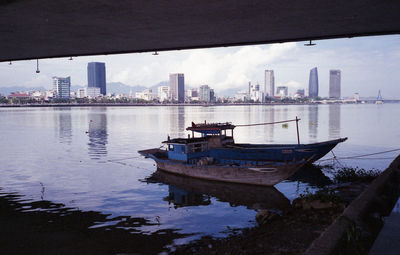 Boats in river with buildings in background