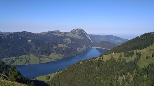 Scenic view of mountains against clear blue sky