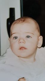 Close-up portrait of cute boy at home