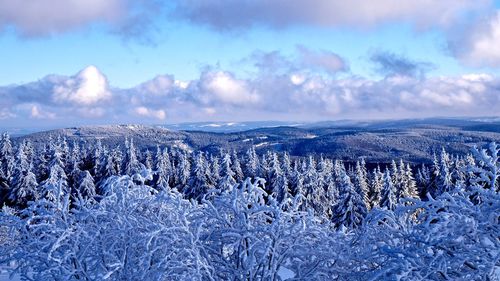 Scenic view of snow covered mountains against sky