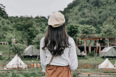 Rear view of woman standing on field