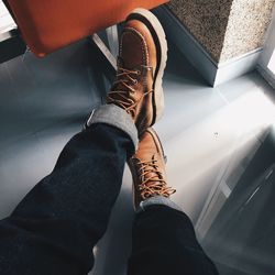 Low section of people sitting on tiled floor