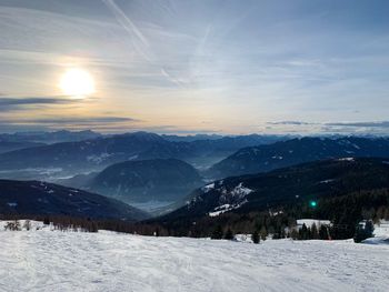 Scenic view of snow covered mountains against sky