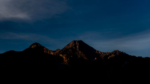 Scenic view of silhouette mountains against sky