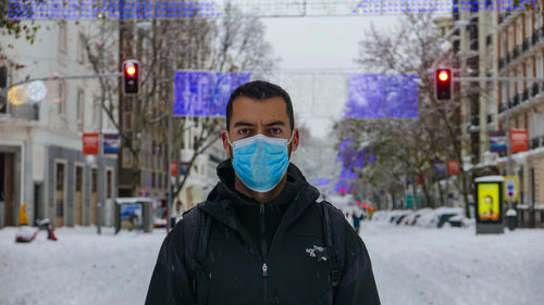 Portrait of man standing in snow