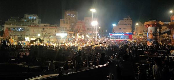 People on illuminated street at night