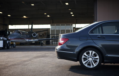 Car parked at airplane hangar