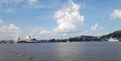 Panoramic view of sea and buildings against sky
