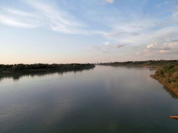 Scenic view of lake against sky at sunset