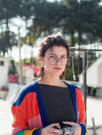 Portrait of young woman standing outdoors