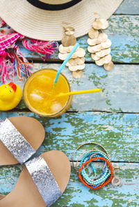 High angle view of hand holding drink on table