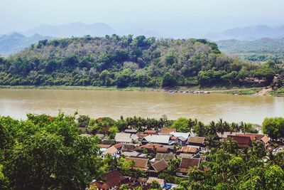 High angle view of river by trees against sky