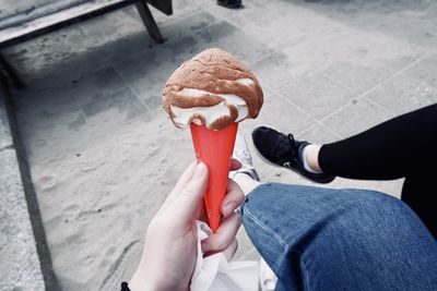 Low section of person holding ice cream cone