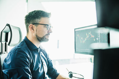 Side view of man working in office