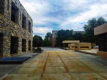 Buildings against cloudy sky
