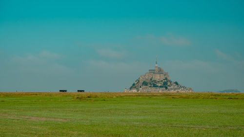 Panoramic view of temple on field against sky