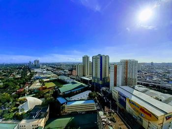 High angle view of buildings against blue sky