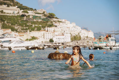 Side view of girl swimming in sea