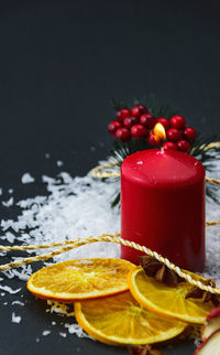 Close-up of christmas decorations with snow on black background