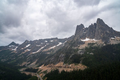 Scenic view of mountains against cloudy sky