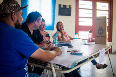 Portrait of young woman sitting on table