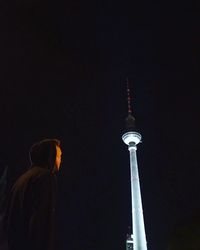 Low angle view of communications tower at night