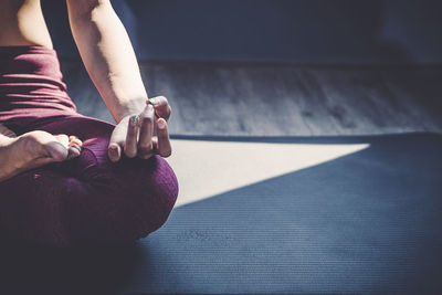 Low section of woman sitting on floor