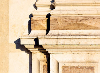 Detail of old marble column at sunset