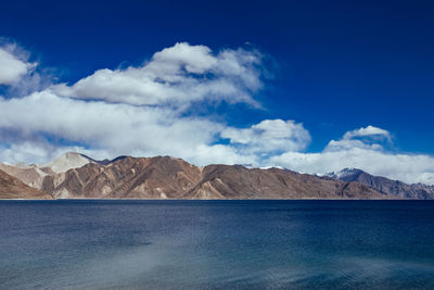 Scenic view of mountains against blue sky