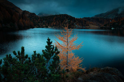 Scenic view of lake and mountains against sky