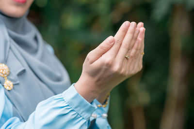 Close-up of hand holding hands outdoors