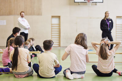 Children having class in school gym