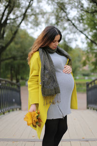 Woman standing on yellow flower