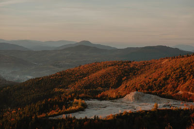 Scenic view of lake by mountains against sky