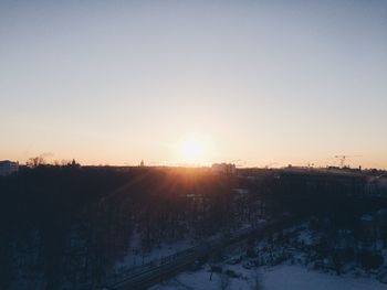 Scenic view of snow against clear sky during sunset
