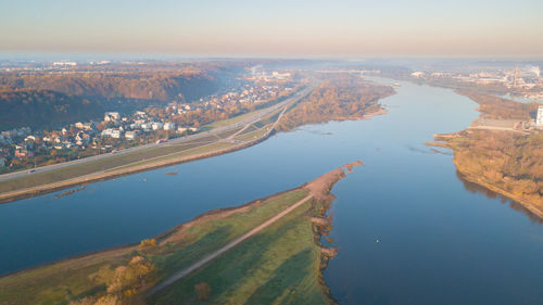 High angle view of sea and cityscape against sky