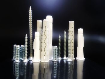 Close-up of illuminated lighting equipment against black background