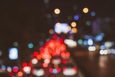 Defocused image of illuminated city at night