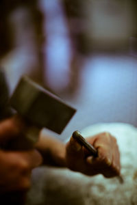Cropped image of hand holding sunglasses