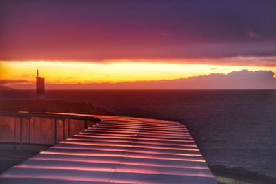 Scenic view of sea against romantic sky at sunset