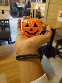 Midsection of woman holding pumpkin