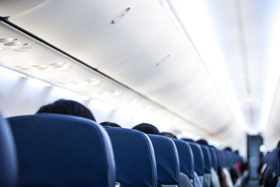 Rear view of man sitting in airplane