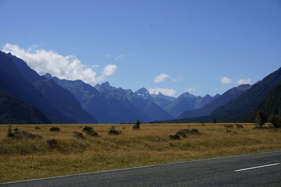 Scenic view of mountains against blue sky