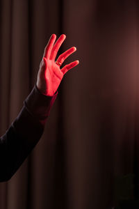 Close-up of hand on red finger