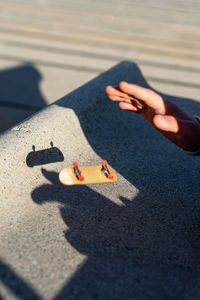 Riding a mini skateboard or fingerboard on outdoors ramp