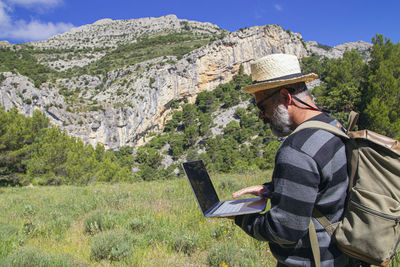 Rear view of man with hat on mountain