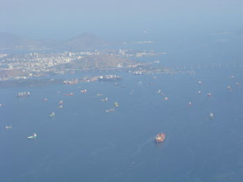 High angle view of sea and cityscape against sky