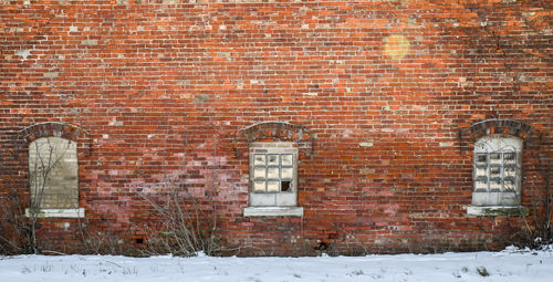 Abandoned prison windows and brick wall