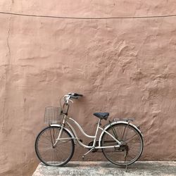 Bicycle leaning against wall