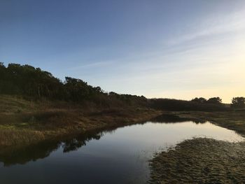 Scenic view of lake against sky during sunset